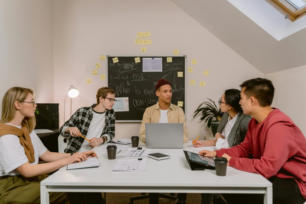 A diverse group of professionals brainstorming ideas during a business meeting in a modern office.